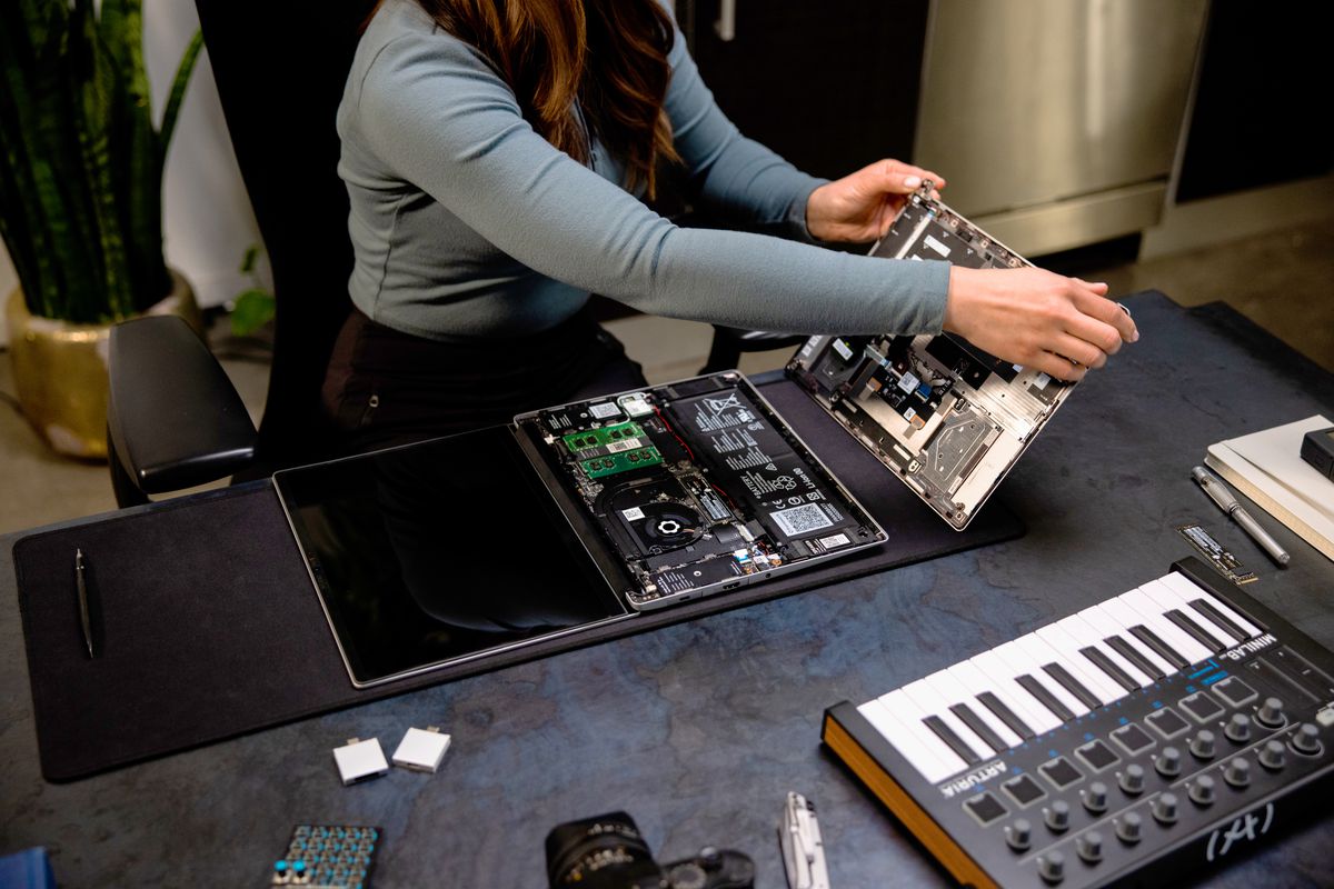 A user disassembles a Framework Laptop.