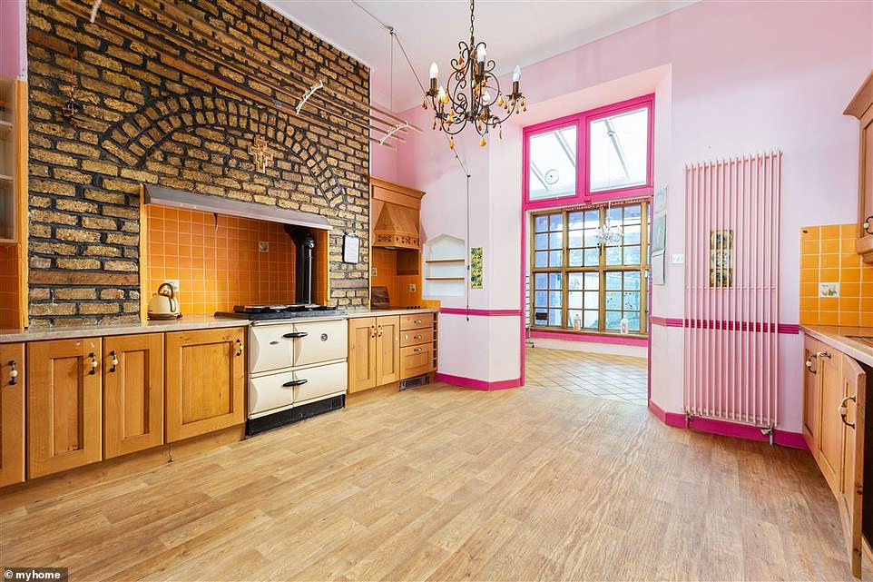 Hard to miss! The kitchen has been painted a striking shade of candyfloss pink, with a Victorian-style over and woodwork adding to the vintage feel