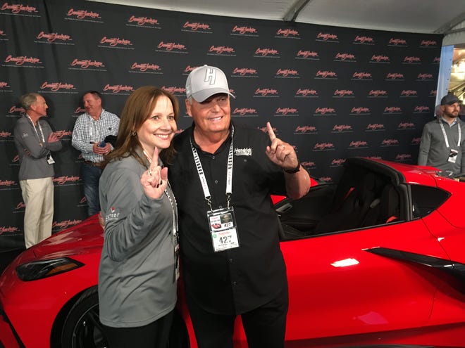 GM CEO Mary Barra and Corvette collector Rick Hendrick at the auction block where Hendrick paid $3 million for VIN #0001 of the first mid-engine Corvette.