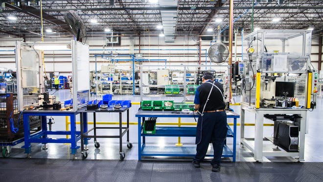 A Borg Warner employee works in their manufacturing facility's EFR work area.