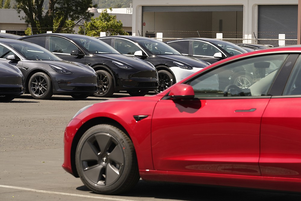 New electric cars are parked at a Tesla delivery location and service center Friday, April 2, 2021, in Corte Madera, Calif. The president and auto industry maintain the nation is on the cusp of a gigantic shift to electric vehicles and away from liquid-fueled cars, but biofuels producers and some of their supporters in Congress aren't buying it and argue now is the time to increase sales of ethanol and biodiesel, not abandon them. (AP Photo/Eric Risberg)