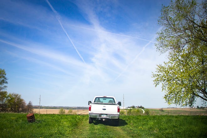 Jim Dane drives his pickup truck toward a bean field, Tuesday, April 27, 2021, near his home off of Dane Road Southwest in Johnson County, Iowa.