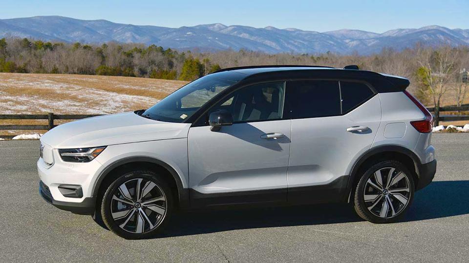 An electric vehicle against the backdrop of mountains.  