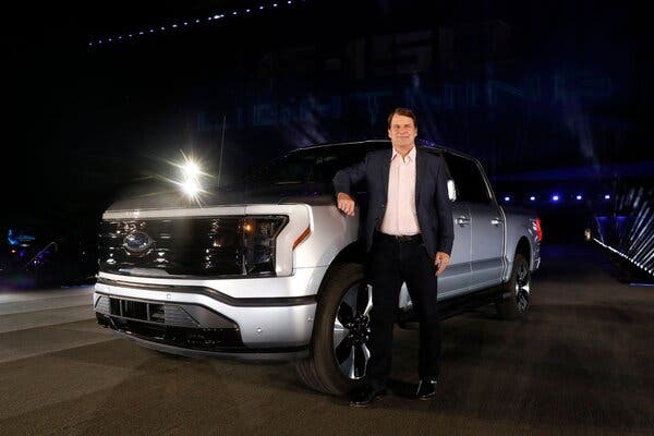 Jim Farley, the chief executive of Ford, with the F-150 Lightning, the electric version of its top-selling pickup truck.