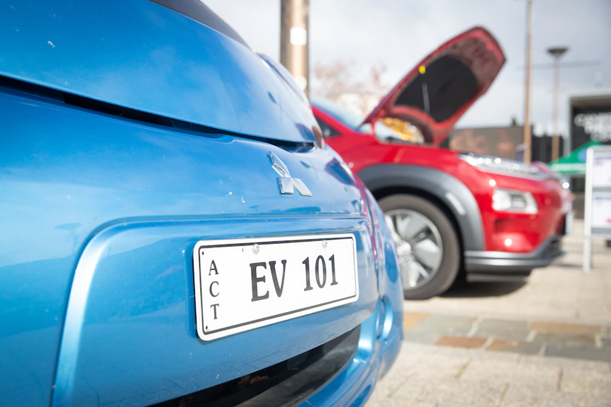 A close up of a licence plate on an electric vehicle reads: EV 101.