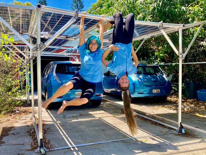 Erika and Toni Ginsberg-Klemmt hang around on their solar carport.