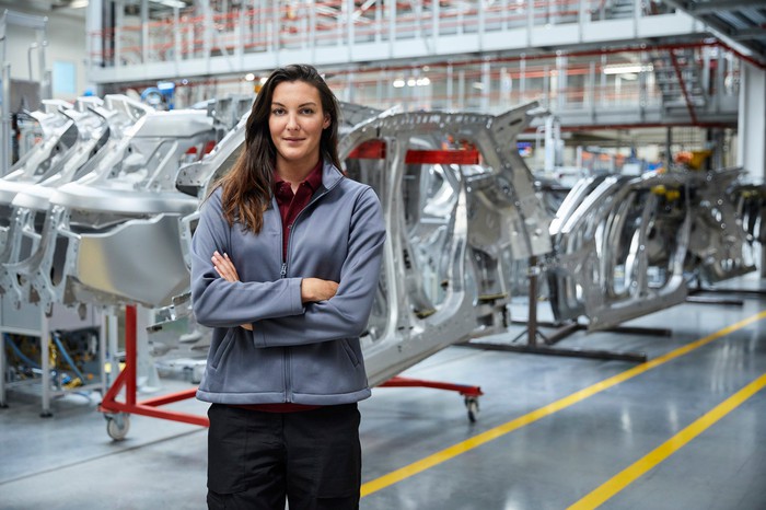 An engineer in front of an auto assembly line.