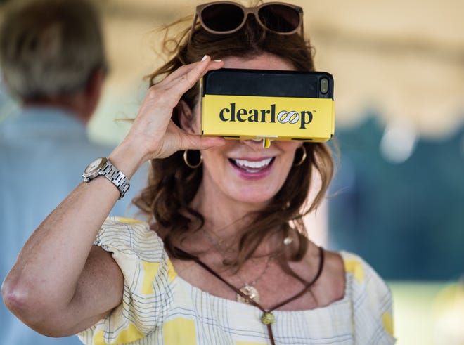 Stacy Clark, author of Planet Power: Explore the World's Renewable Energy and sponsor, tries out the virtual reality headset during Clearloop’s 1 Megawatt solar farm event on Thursday, Sept 2, 2021 in Jackson, Tenn.