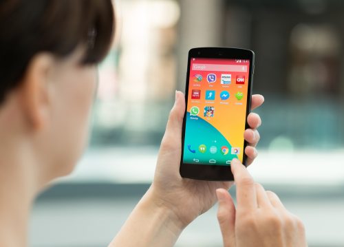 woman using android phone from behind
