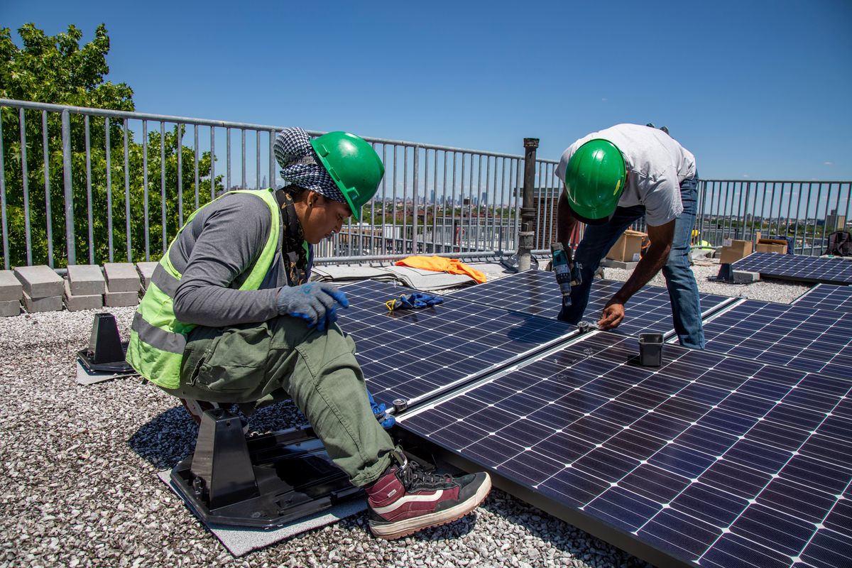 Workers install solar panels at NYCHA’s Kingsborough Houses in Crown Heights.