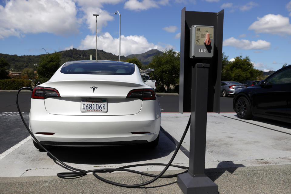 CORTE MADERA, CALIFORNIA - APRIL 26: A Tesla car charges at a Tesla Supercharger station on April 26, 2021 in Corte Madera, California. Tesla will report first quarter earnings today after the closing bell. (Photo by Justin Sullivan/Getty Images)