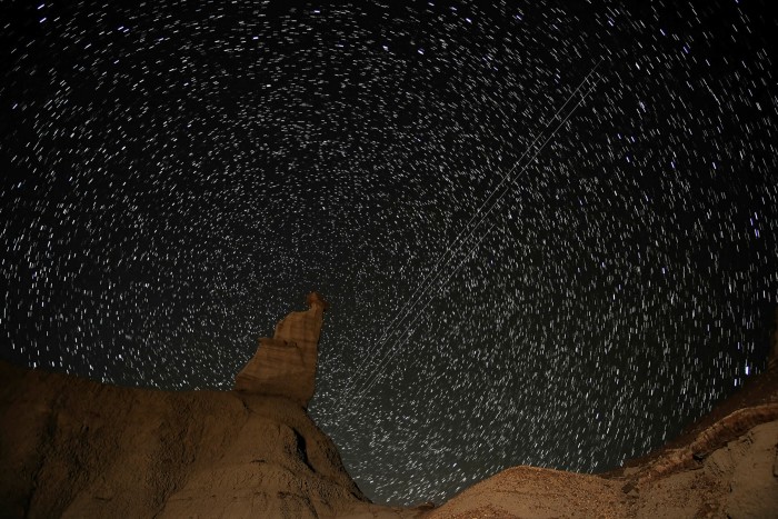 A composite of nine long exposures shows the passage of SpaceX’s Starlink satellites in the Bisti Wilderness of New Mexico, US