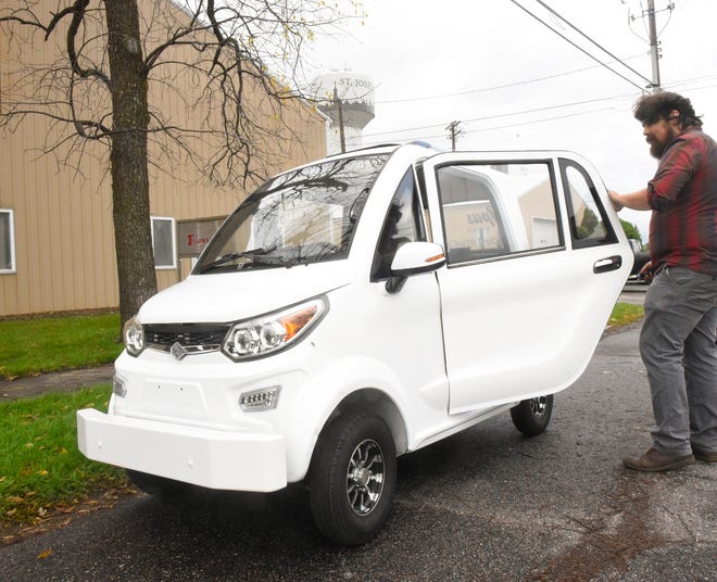 Tom Skahen, CEO of Opus Motorcar Company, opens the door to a prototype car Wednesday, Oct. 13, 2021, in St. Joseph.
