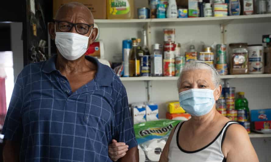 José Vázquez and his wife, Margarita Velázquez, in the supply room of their solar-powered residence in Barrio Jobos in Guayama.