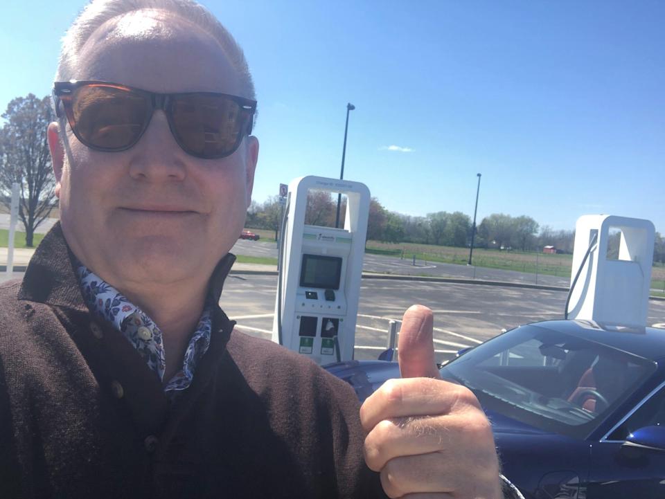 Patrick Anderson gives a thumbs-up after getting a commercial charger to work on a trip to Cleveland, Ohio.